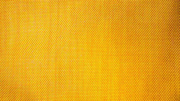 istock orange background from a textile material with wicker pattern, closeup. Structure of the bright  fabric with texture. Cloth backdrop with vignette. 1191808219
