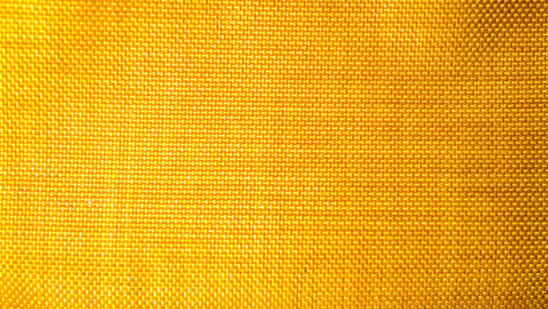 istock orange background from a textile material with wicker pattern, closeup. Structure of the bright  fabric with texture. Cloth backdrop with vignette. 1191808965