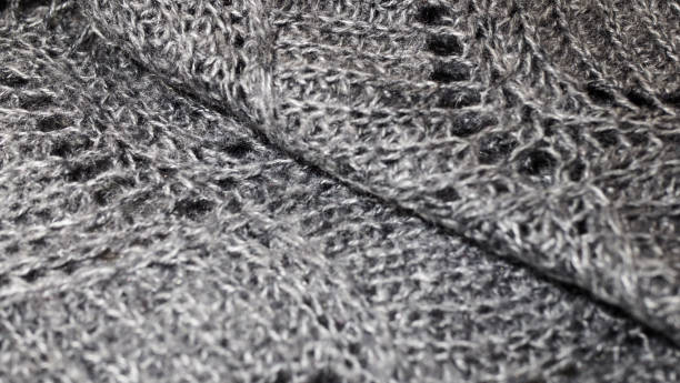 istock fabric background with metallic weave.  Coarse woven gray material with shiny inserts.  Texture of rough curtain fabric with interwoven silver threads.  knitted patterns of thread 1191811471