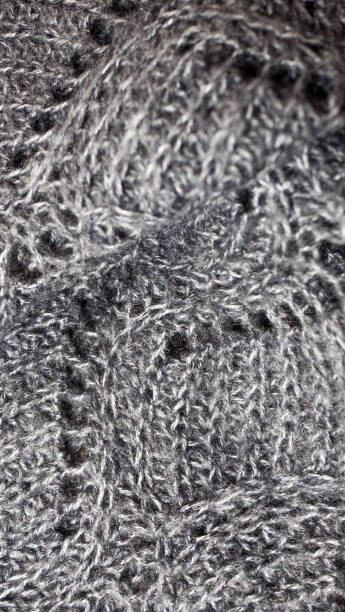 istock fabric background with metallic weave.  Coarse woven gray material with shiny inserts.  Texture of rough curtain fabric with interwoven silver threads.  knitted patterns of thread 1191811518