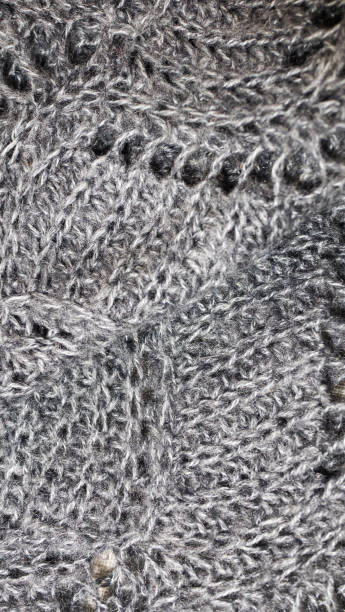 istock fabric background with metallic weave.  Coarse woven gray material with shiny inserts.  Texture of rough curtain fabric with interwoven silver threads.  knitted patterns of thread 1191811621