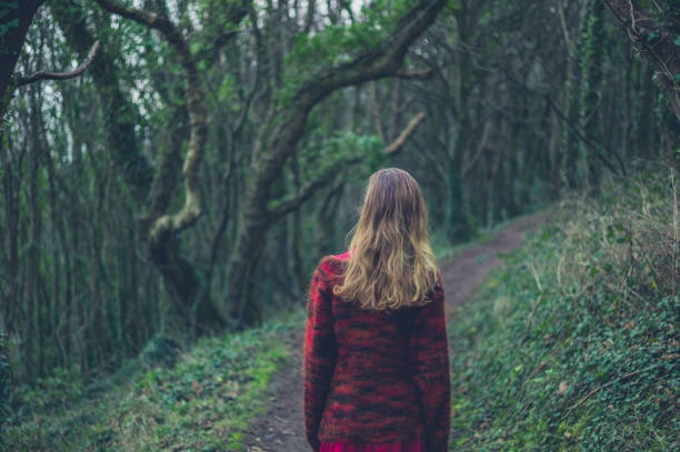 istock Young woman walking in the woods 1191812156