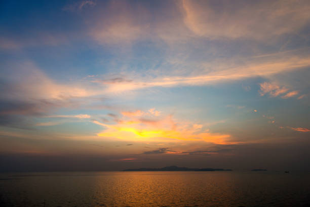 Natural Sunset Sunrise Over Field Or Meadow. Bright Dramatic Sky And Dark Ground. Countryside Landscape Under Scenic Colorful Sky At Sunset Dawn Sunrise. Sun Over Skyline, Horizon. Warm Colours.