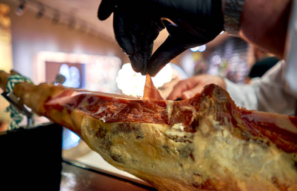 istock man slices ham close up 1191813016