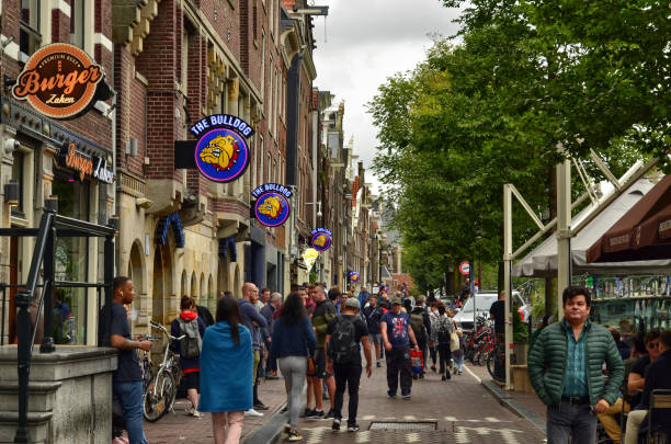 Amsterdam, Holland, August 201. One of the historic coffee shops in the central red-light district: the bulldog. Colored signs with mastin from the barbed collar attract attention.