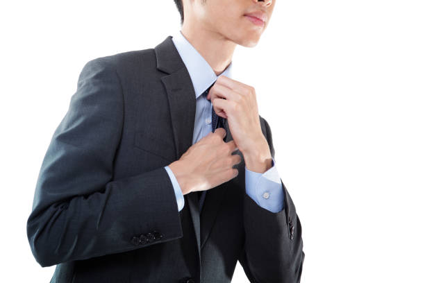 Jade green necktie with a Windsor knot, over white.