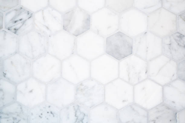 Marble hexagon tile floor background pattern with gray grout stock photo