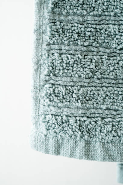 istock Green soft plush towel hanging from hanger background close up 1191815691