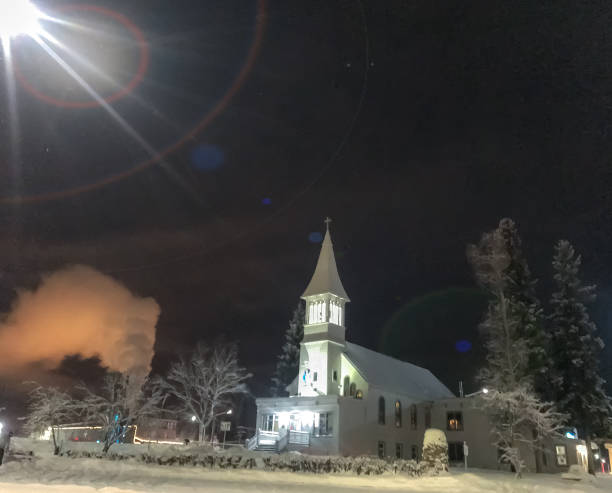A church spire stands out against a night sky. A symbol of faith, this church is a metaphor for ones faith shining in the darkness.