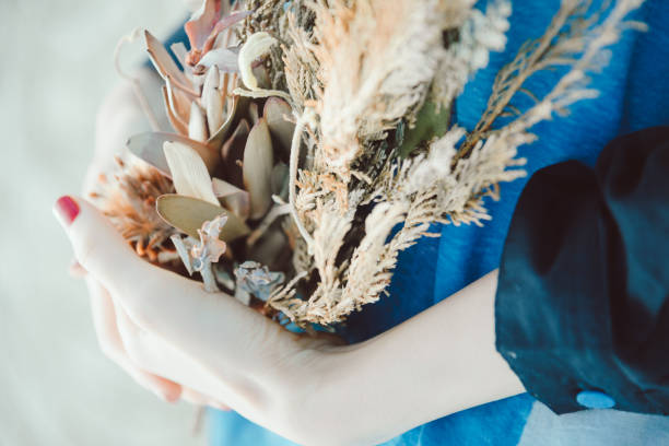 Woman holding a flower.