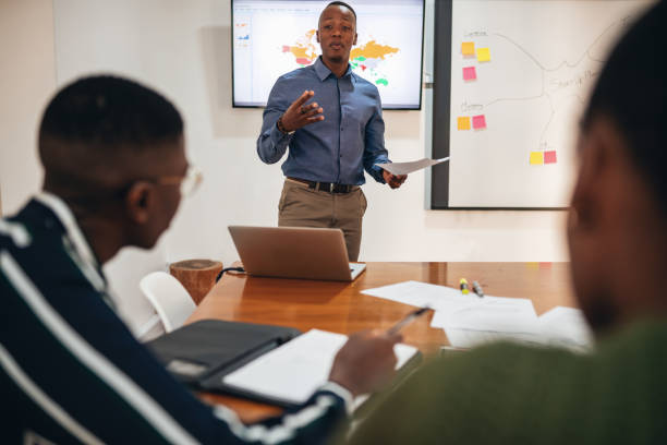 istock Confident Male Professional Discussing With Colleagues 1191816318