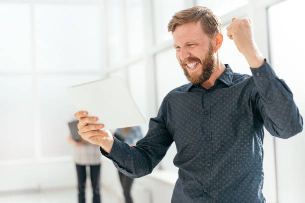 istock happy man getting good news on his email 1191818109