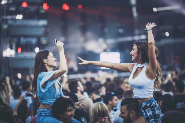 istock Young happy couples having fun while dancing on a music festival. 1191818153