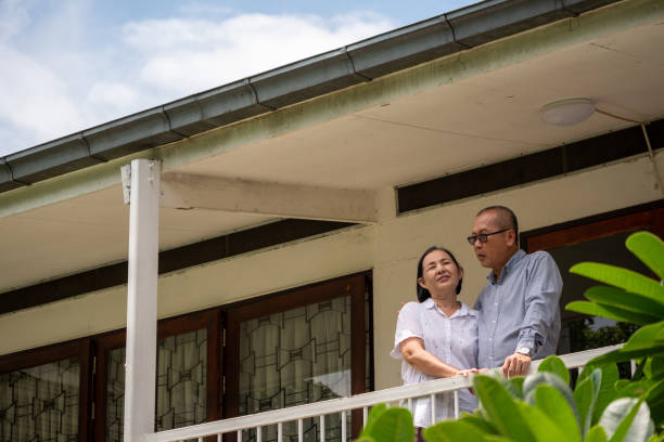 istock Happy asian couples standing at the balcony and talking together. 1191818444
