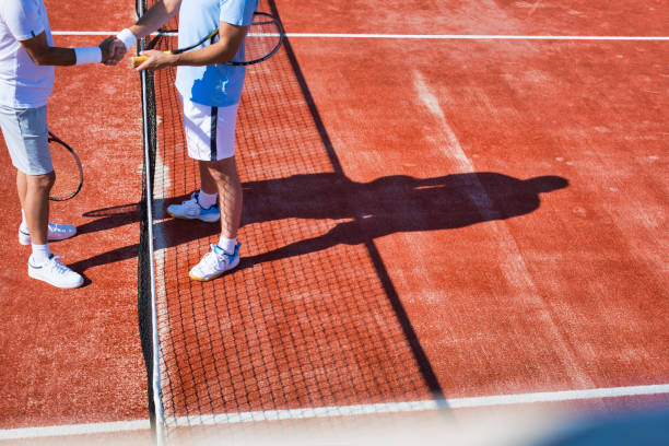 istock Men greeting while standing on tennis court during summer match 1191818470