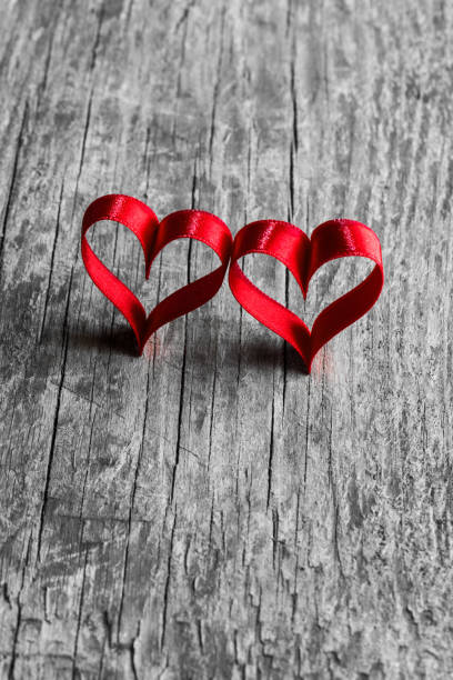 istock Red ribbon hearts on wood 1191819419