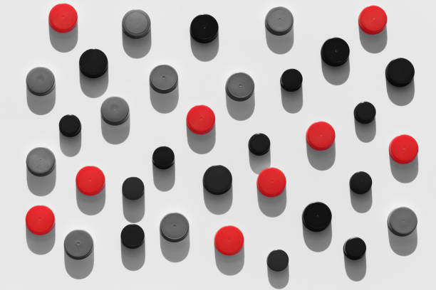 istock Plastic bottle caps background with black and red color pattern 1191819617
