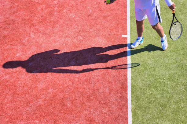 istock Confident mature man playing tennis on sunny day 1191820010