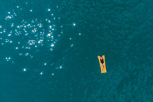 young woman swimming in blue azure water. summer vacation