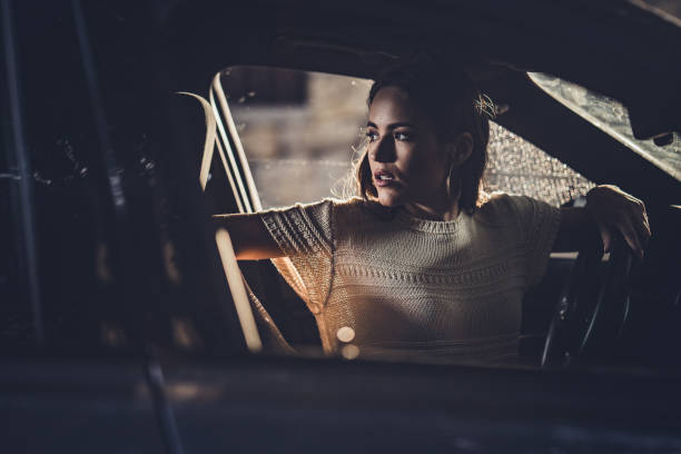 istock Young beautiful woman parking her car in reverse. 1191820654