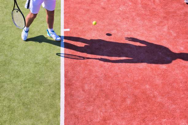 istock Confident mature man playing tennis on sunny day 1191821015