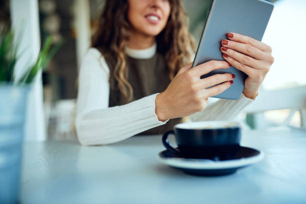 istock Attractive young curly brunette looking at her tablet and smiling 1191821030