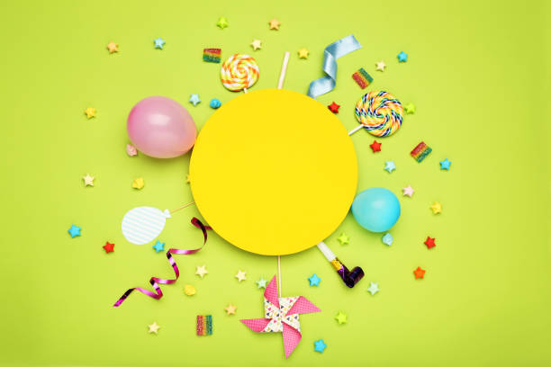 istock Colorful flat lay composition with various party items and candies on green background 1191822308