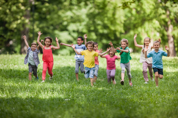 istock Carefree children having fun while running in spring day at the park. 1191822445