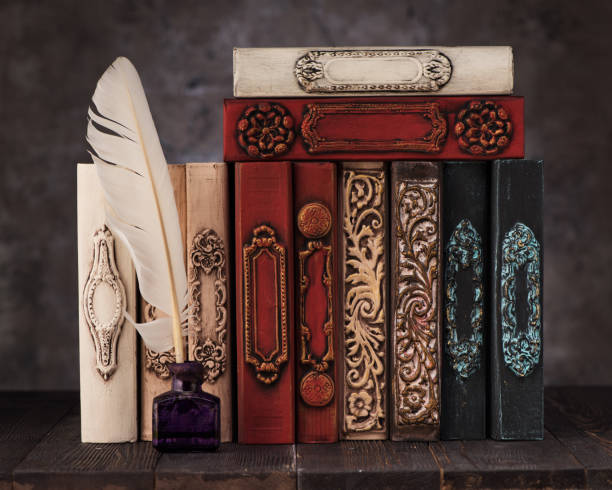 istock stack old vintage books on shelf, antique inkwell and feather for writing 1191825901