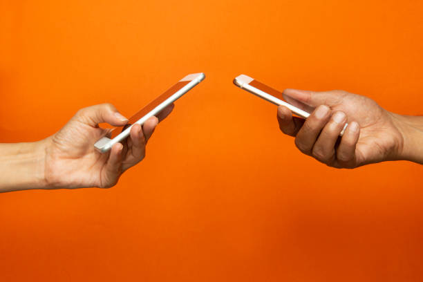 Two Hands Holding Mobile Phones