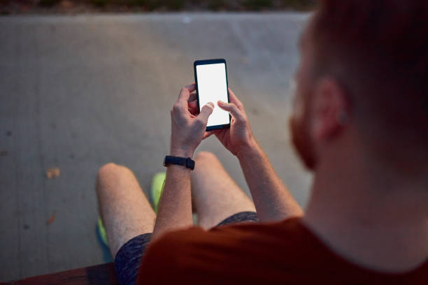 istock Man using cellphone in urban park at night. 1191828504