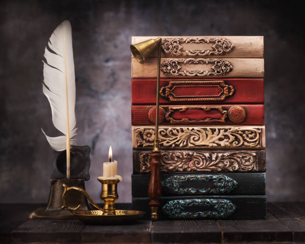 istock stack old vintage books on shelf, antique inkwell and feather for writing 1191829577