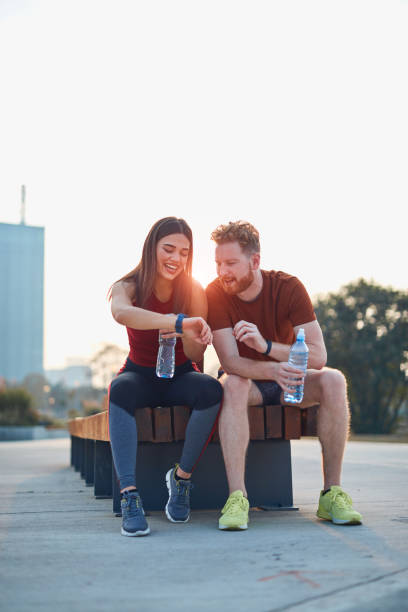 istock Modern couple making pause in an urban park during jogging / exercise. 1191829616