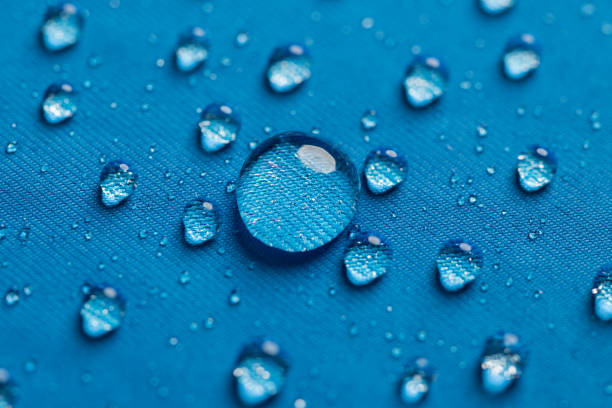 Water dropplets on a waterproof fabric Water dropplets on a waterproof breathable fabric used for clothing water repellent stock pictures, royalty-free photos & images