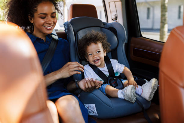 istock Happy kid sitting on a backseat with his mother 1191833591