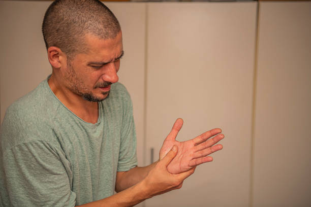 istock Man with a Pain in his Hand Wrist 1191834840