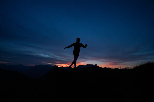 istock Trail runner runs along mountain ridge at sunrise 1191836394