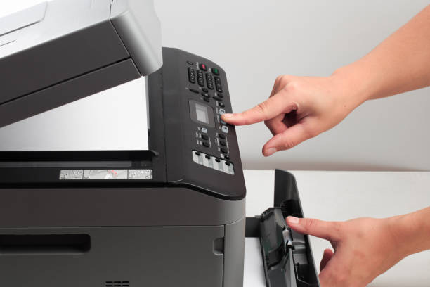 istock Hand press button on panel of printer. printer scanner laser office copy machine supplies start concept 1191836558