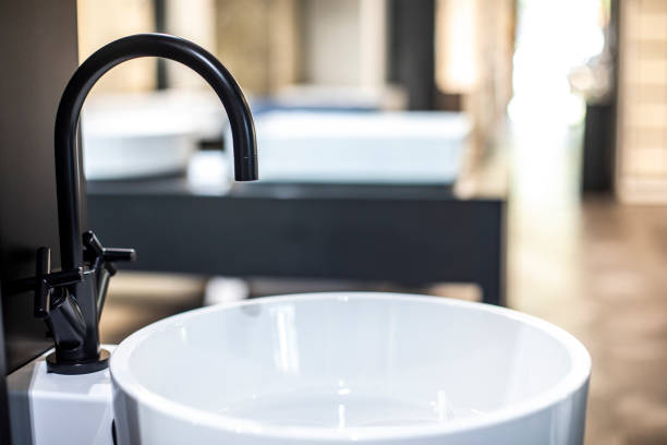 istock A fancy black faucet placed on a white bathroom sink 1191836662