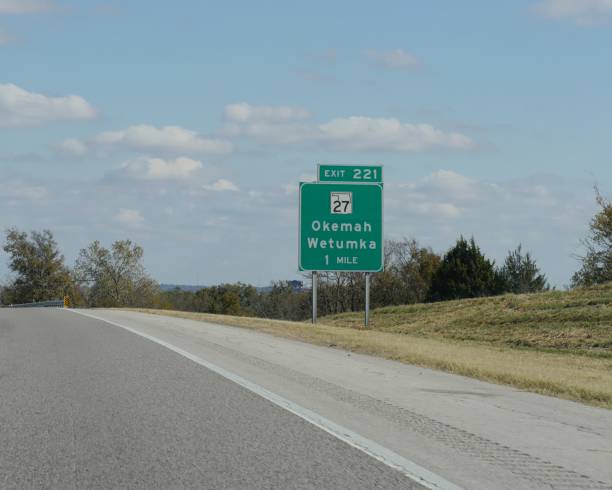 wegweiser mit wegbeschreibung nach okemah und wetumka in oklahoma. - oklahoma sign road sign sky stock-fotos und bilder