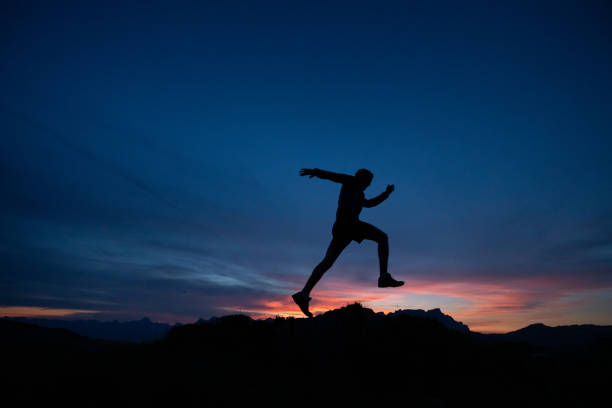 istock Trail runner runs along mountain ridge at sunrise 1191837509