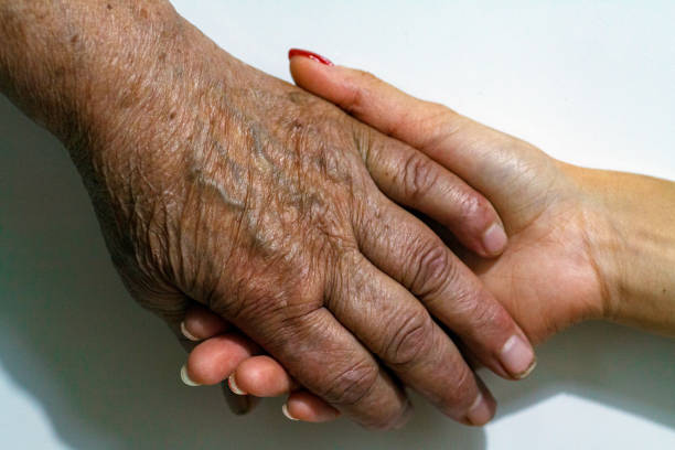 istock Old and Young Women Holding Hands 1191837800