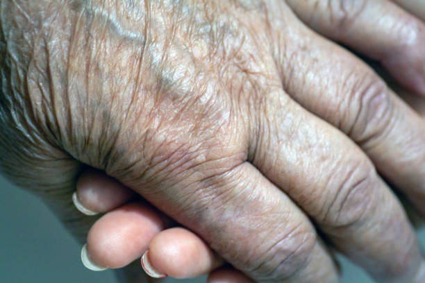 istock Old and Young Women Holding Hands 1191837859
