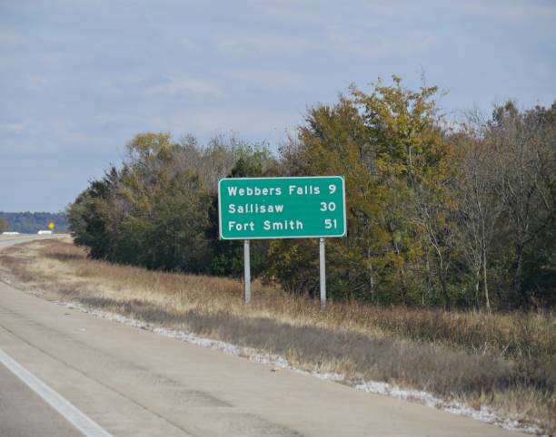 istock Roadside sign with distances to Webbers Falls, Sallisaw and Fort Smith. 1191838018