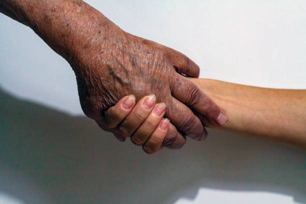istock Old and Young Women Holding Hands 1191838724