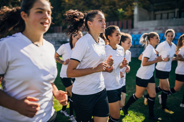 istock Ladies soccer team jogging together 1191840097
