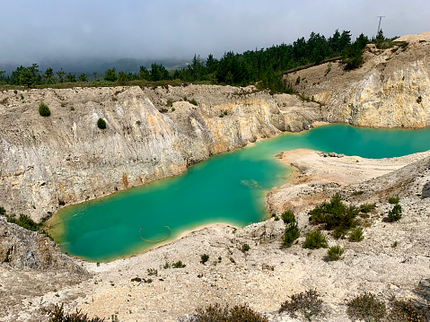 Old tungsten (wolfram) mine is now a toxic, abandoned but beautiful green lake. Mount Neme, Spain