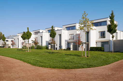 Brand new luxury one-family houses and clear sky, alawn and acurved footpath in the foeground, Duesseldorf, Germany.