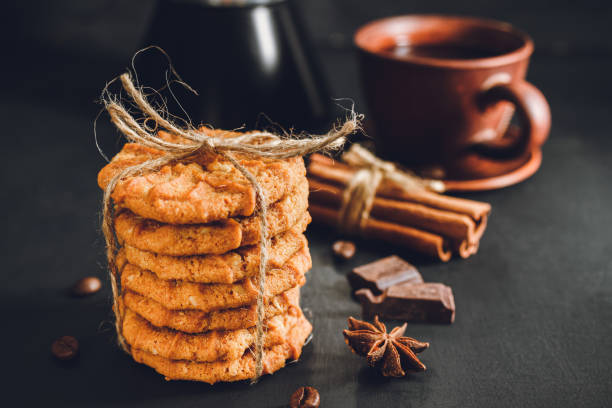 istock Homemade chip cookies stacked on dark background 1191849260