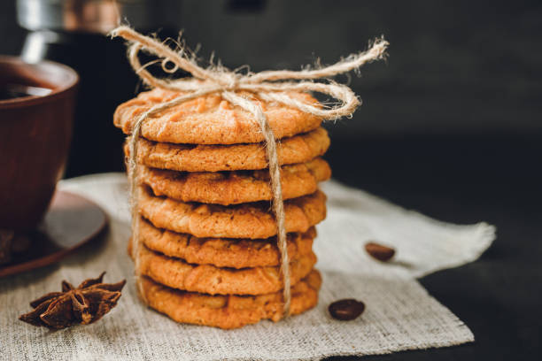 istock Homemade chip cookies stacked on dark background 1191849262